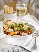 Pasta with tomatoes, rocket and cheese shavings
