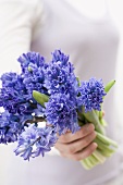 Woman holding blue hyacinths