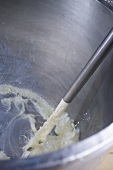 Milk running into a stainless steel vessel