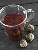 Glass of tea with tea blooms
