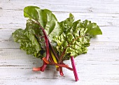 Chard leaves on wooden background