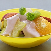 Fruit salad with yoghurt sauce and mint