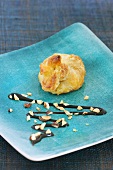 Puff pastry purse with balsamic sauce and chopped nuts