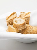 Several baguette slices in a bread basket