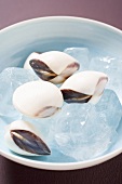 Asian shellfish in a dish of ice cubes