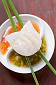 Dim sum with sesame seeds on two sauces (China)