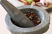 Peppercorns in mortal with pestle