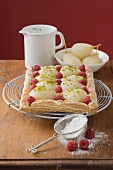 Puff pastry pear and raspberry tart, icing sugar