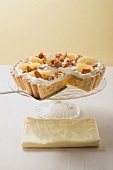 Apple tart with cream and nut brittle, a piece cut