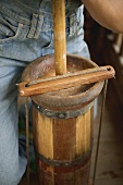 Person churning butter in a butter churn