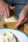 Shaping farmhouse butter in a wooden mould