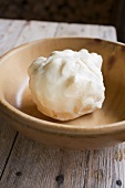 Ball of butter in wooden bowl
