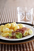 Leek wrapped in bacon with new potatoes