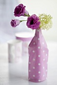 Lisianthus and viburnums in a vase