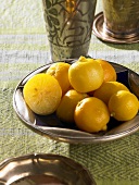 Pickled lemons in a metal bowl