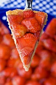A slice of strawberry tart on a cake server