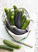 Fresh courgettes and aubergines in a wire basket