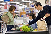 Junges Paar an der Kasse in einem Supermarkt