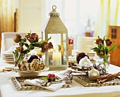 Christmas table with stollen, lantern and Christmas roses
