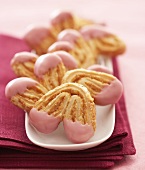 'Pig's ears' with pink glacé icing 