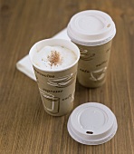 Coffee with milk froth in paper cups (Coffee to go)