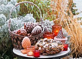 Table decorated with pine cones and spice wreath