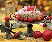 Ornamental apples and Clematis seed heads in an iron bowl