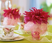 Dahlias in glasses with coloured sisal and pearls