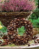 Wreath of chestnuts and autumn leaves, heather behind