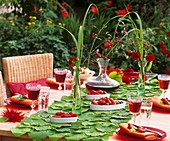 Table decoration: pipevine leaves, peppers and dahlias