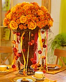 Chrysanthemums and roses in wicker vase