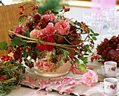 Arrangement of roses, rose hips, Clematis and Amaranthus
