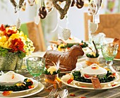 Table laid for Easter with soup bowls and Easter lamb