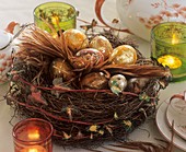 Osternest aus Drahtwein und Efeu, gefüllt mit golden marmorierten Ostereiern
