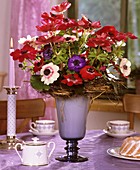 Table with Anemone coronaria, cups and mini-gugelhupf