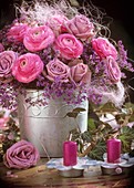 Arrangement of ranunculus, roses, sea lavender and sisal