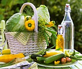 Various types of vegetables and herbs in a white basket