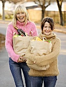 Two friends with bags of shopping