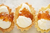 Almond pastry shells filled with cream and jam