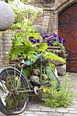 Rostiges Motorrad an Ziegelmauer im Garten