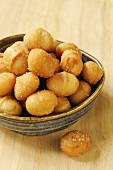 Small bowl of roasted, salted macadamia nuts