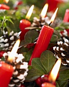 Christmas decoration with candles and pine cones