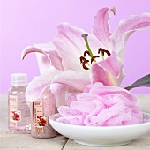 Pink lily, bath puff and bath products