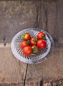 Several tomatoes, variety 'Maigloeckchen', on glass plate