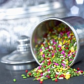 Coloured peppermints from India in upset storage tin