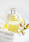 Massage oil with orchids on towels