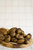 Fresh potatoes on a wooden board