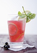 A glass of Cassis lemonade with basil