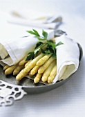 Cooked asparagus with parsley on a cloth