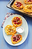 Sweet mini-pizzas topped with grapes and rosemary
